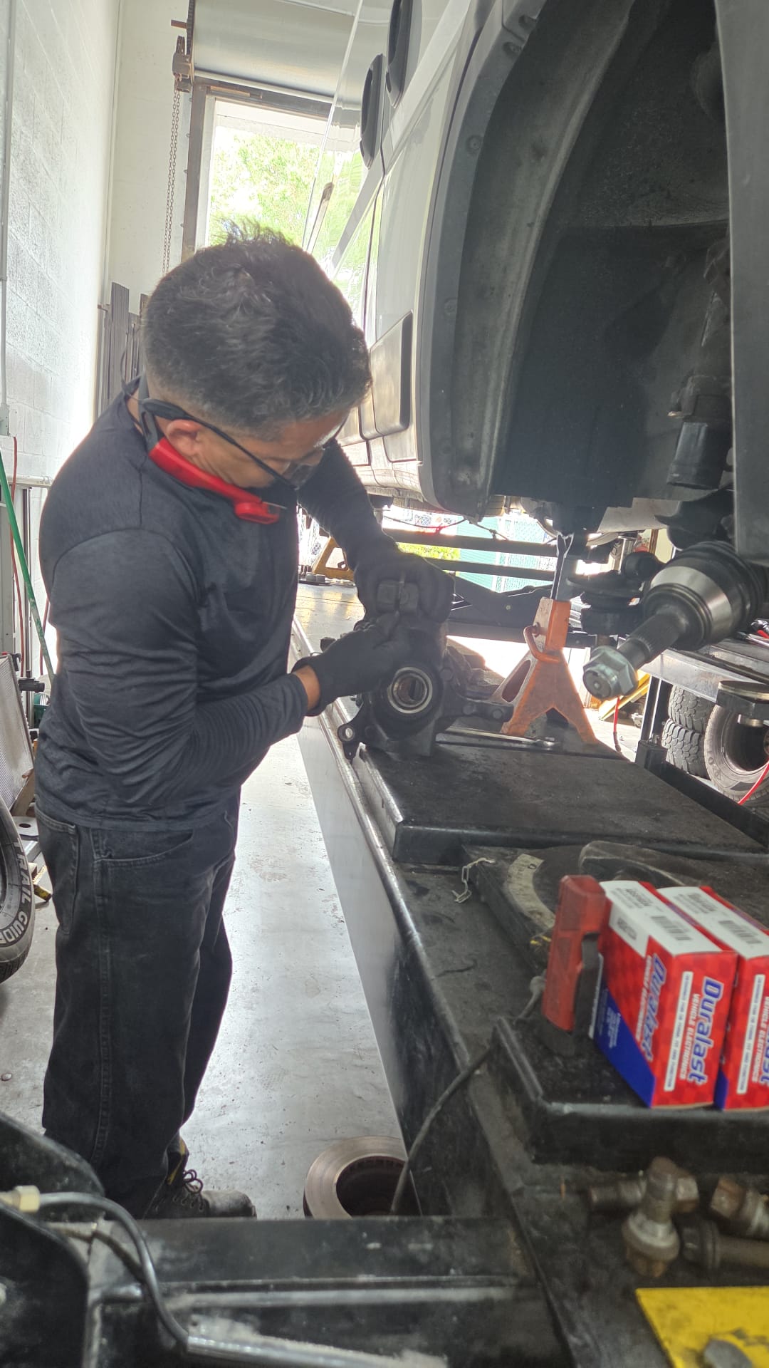 Mechanic working on wheel assembly